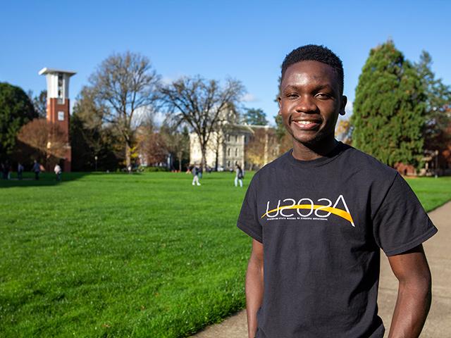 Omondi smiling while standing in the MU Quad